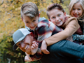 Man with three children on his back