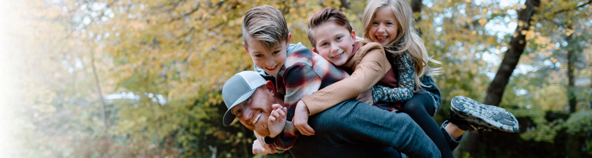 Man with three children on his back