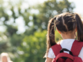Girl getting on a school bus
