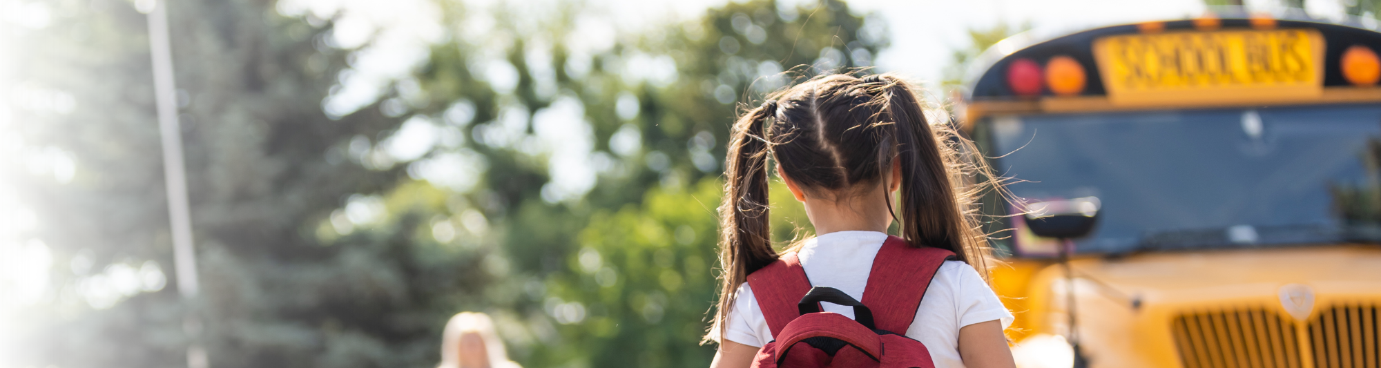 Girl getting on a school bus