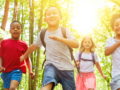 Children running on a forest trail